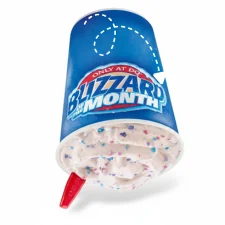 Cotton Candy Blizzard Treat held upside down showing vanilla soft serve mixed with colorful cotton candy pieces and rainbow sprinkles