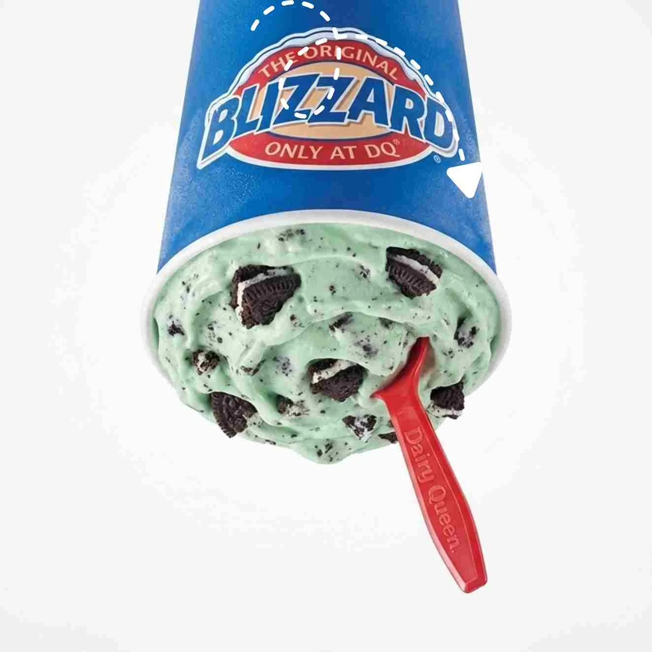 Mint OREO Blizzard Treat held upside down showing mint green soft serve ice cream mixed with OREO cookie pieces