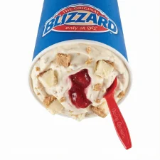 Royal New York Cheesecake Blizzard® Treat with vanilla soft serve, cheesecake pieces, and strawberry filling