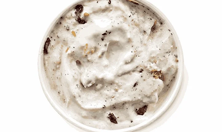 Choco Frosted Donut Blizzard - vanilla soft-serve ice cream blended with chocolate frosted donut pieces, served in a Dairy Queen cup